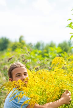 Child in ragweed flowers allergy. Selective focus. Kid.