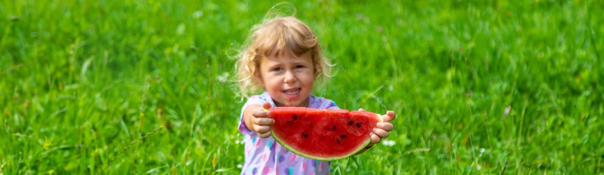 Child eats watermelon in summer. Selective focus. Kid.