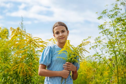 Child in ragweed flowers allergy. Selective focus. Kid.