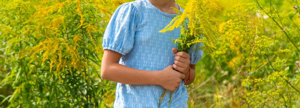 Child in ragweed flowers allergy. Selective focus. Kid.