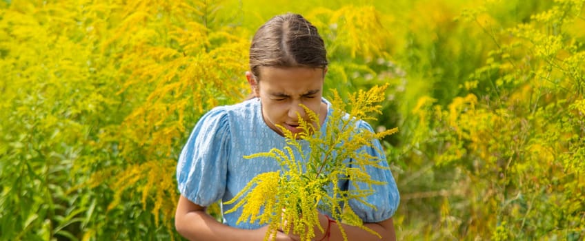 Child in ragweed flowers allergy. Selective focus. Kid.