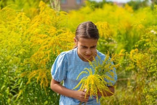 Child in ragweed flowers allergy. Selective focus. Kid.