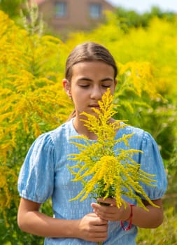 Child in ragweed flowers allergy. Selective focus. Kid.