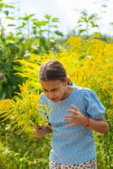 Child in ragweed flowers allergy. Selective focus. Kid.