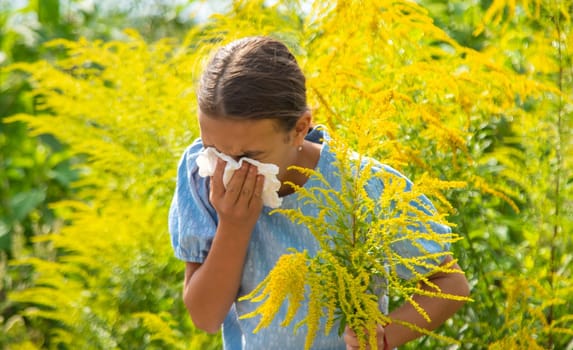 Child in ragweed flowers allergy. Selective focus. Kid.
