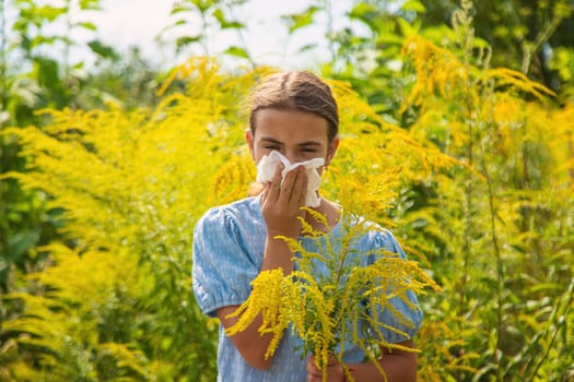 Child in ragweed flowers allergy. Selective focus. Kid.