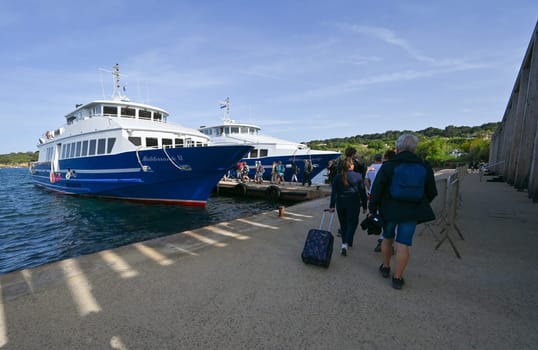 Porquerolles, France - June 14 2024: Passenger ferry between Hyeres and Porquerolles island making an arrival maneuver. High quality photo