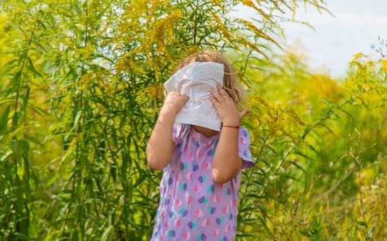 Child in ragweed flowers allergy. Selective focus. Kid.