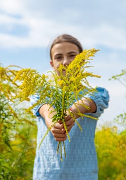 Child in ragweed flowers allergy. Selective focus. Kid.