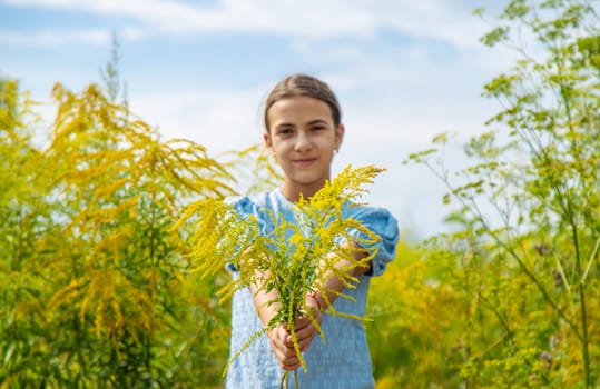 Child in ragweed flowers allergy. Selective focus. Kid.