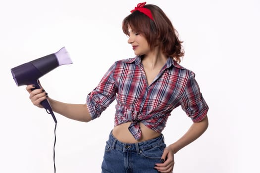 A stylish and trendy young woman is playfully holding a hair dryer, showcasing exciting and fashionable beauty vibes