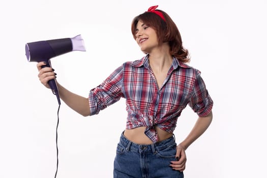 A stylish young woman poses playfully with a hair dryer, showcasing her unique fashion sense and fun spirit