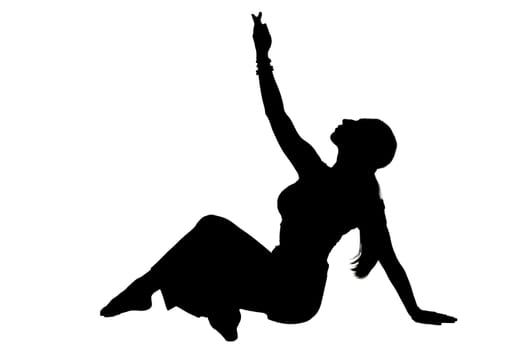 A striking silhouette of a woman gracefully sitting on the floor with her arms elegantly outstretched in a beautiful pose