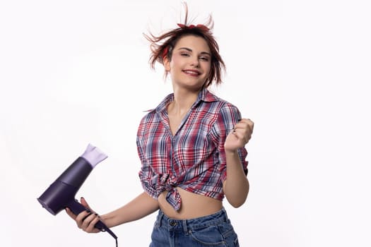 A cheerful woman happily dancing with a hair dryer in her hand, showcasing her vibrant energy and unique style