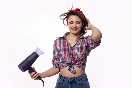 A trendy and fashionable young woman holding a hair dryer, fully embracing both style and beauty in her life