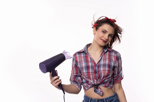 A confident and stylish woman poses playfully with a hair dryer, showcasing the latest modern beauty and fashion trends