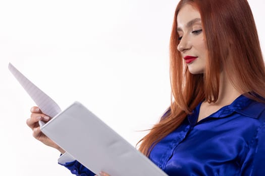 A confident woman carefully examines important documents, showcasing her elegance and professionalism with style