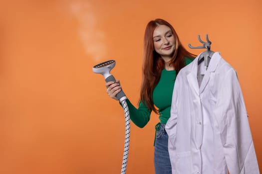 A woman uses a steamer on a white shirt, showcasing the importance of garment care and modern laundry tools