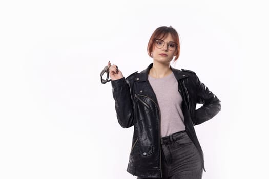 A fashionable young woman poses confidently in an elegant and stylish black ensemble complemented by chic accessories