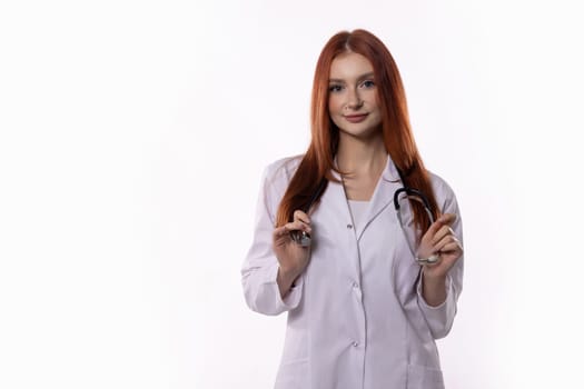 A confident young female doctor wearing a lab coat with a stethoscope is fully prepared and ready to assist patients