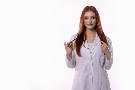 A skilled female doctor in a lab coat and stethoscope is ready to assist patients needing care and support