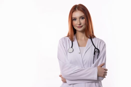 A confident female doctor in a white coat stands with arms crossed, highlighting her professionalism and expertise