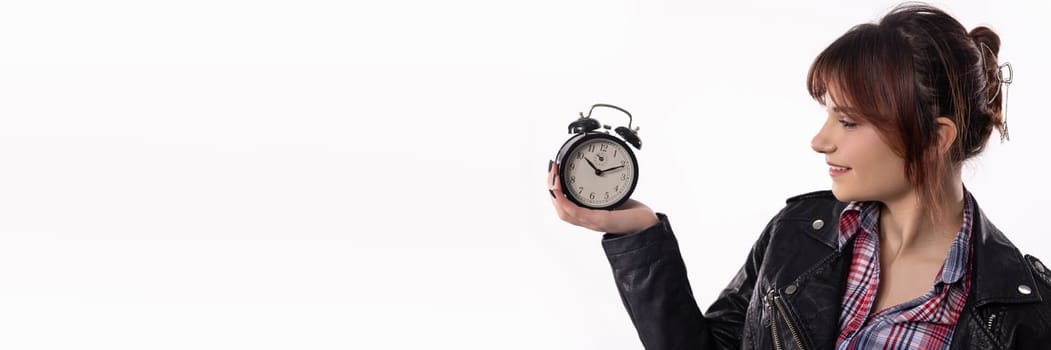 A stylish woman with a bright smile holds an alarm clock, embodying time management, elegance, and flair