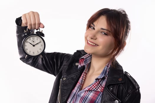A stylish young woman holds an alarm clock, symbolizing time management and her unique personal style