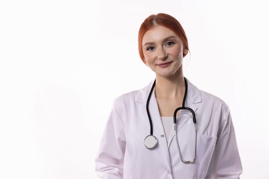 A smiling female doctor in a white coat holds a stethoscope, showcasing her professionalism and compassion