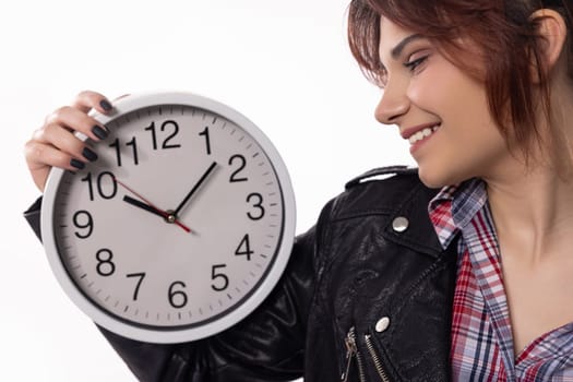 A stylish and modern woman beams with joy while elegantly holding a clock, embodying a vibrant sense of time