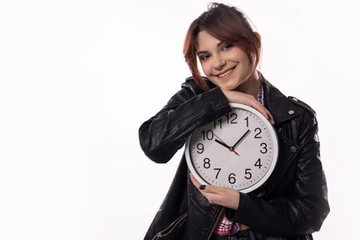 A cheerful young woman joyfully poses with a clock, beautifully embodying themes of time and a vibrant lifestyle