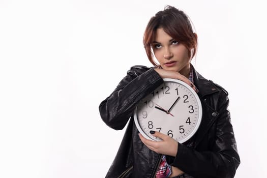 A fashionable woman is holding an oversized clock, which symbolizes the relentless passage of time itself