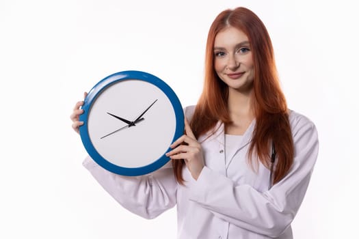 A young woman in a lab coat holds a blue clock, symbolizing effective time management and precise scheduling