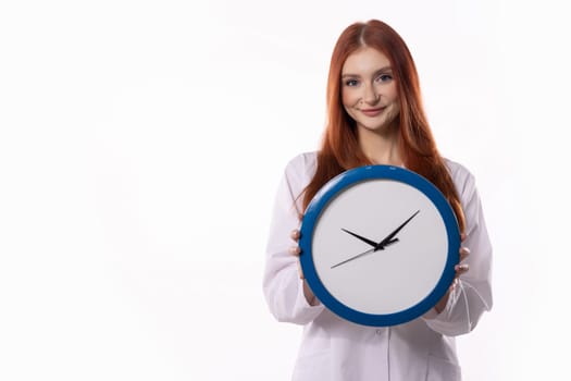 A cheerful woman poses with a large clock, symbolizing time management and readiness for challenges