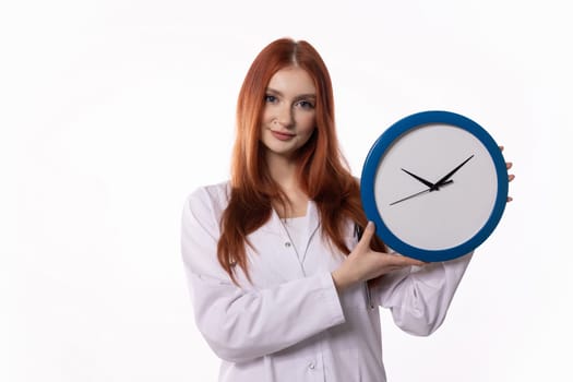A young woman wearing a lab coat is showcasing a clock, which symbolizes the importance of effective time management