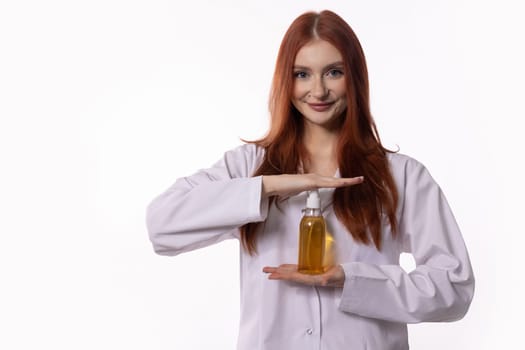 A smiling young woman in a lab coat showcases an innovative hair care product, highlighting beauty and wellness