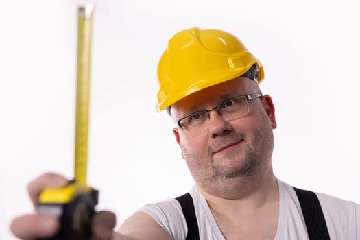 A construction worker is there with a measuring tape, showcasing the importance of safety and precision in the field