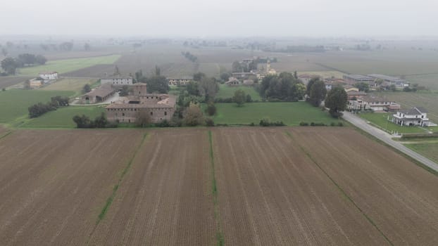Piacenza, Italy October 15th 2024 An aerial view of an ancient castle surrounded by farmland, showcasing the italian countryside