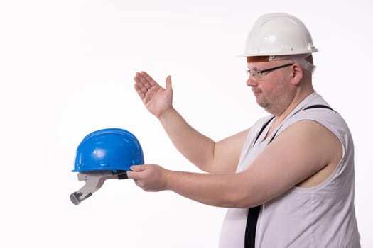 A construction worker clearly demonstrates the critical importance of wearing safety gear, including a hard hat