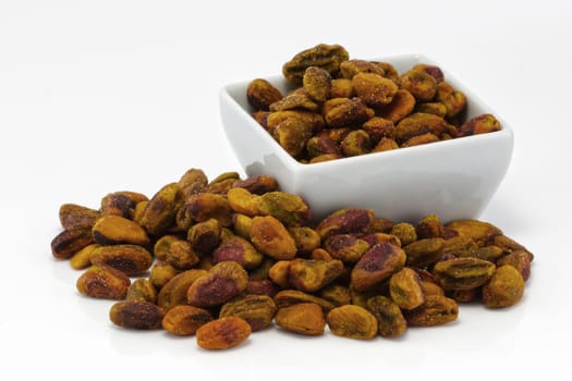 Pistachio nuts in a group on white
