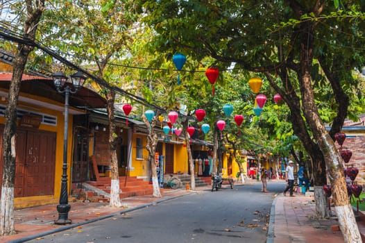 Beautiful ancient asian streets in the old town of Hoi An city with historic houses and green trees. Hoi An, Vietnam - September 12, 2024