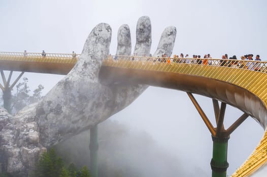 Golden Bridge is also known as the Hands of God in Ba Na Hills Park in Da Nang on the mountain in the fog. Da Nang, Vietnam - September 13, 2024