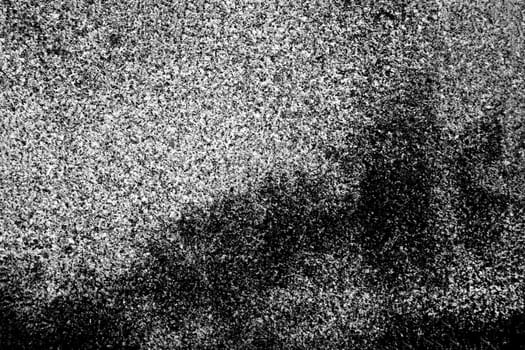 The surface of an old, abandoned stone wall. Black and white background for design.