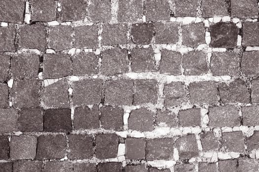 Old walled up antique gray brick wall.
