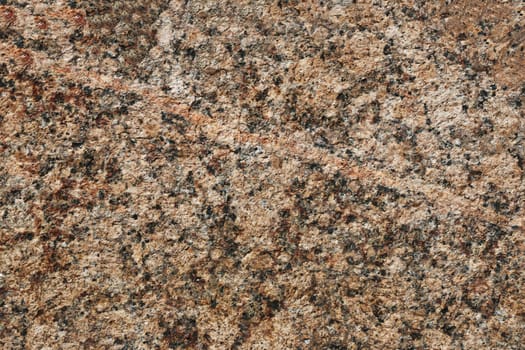 Granite texture. Natural red granite with a grainy pattern. Stone background. Solid rough surface of rock.