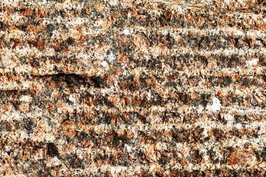 Brown stone wall close up. Abstract background from the surface of a stone slab.