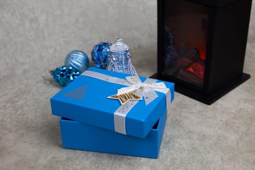 Slightly open gift box for New Year holiday on light background, place for gifts for Christmas. Decorated gift wrapping for New Year present
