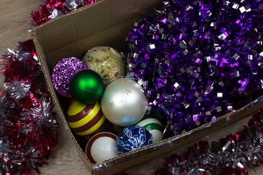 Christmas toys in cardboard box, storing Christmas tree toys for decorating your home for New Year, attributes of winter holidays, seasonal objects for decoration
