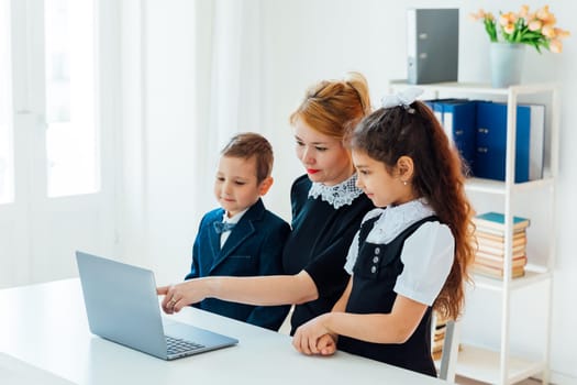 Woman School Teacher In Classroom In Class With Kids