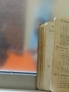 Old little music book of church's music. Old paper book.